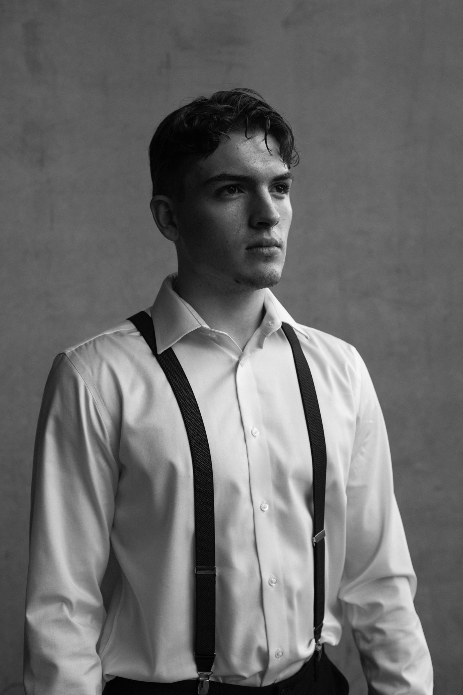 Man in suspenders, a still moment before